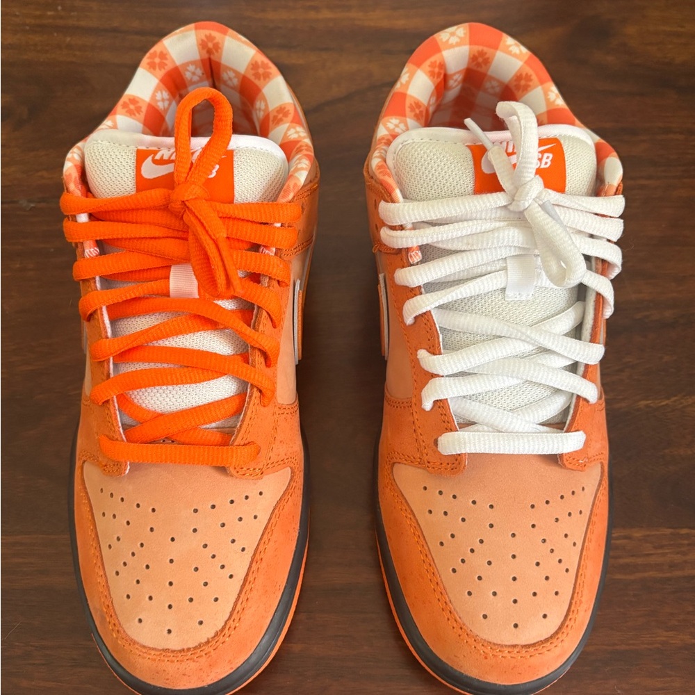 White and orange athletic shoe - off brand - not on brand/designer.